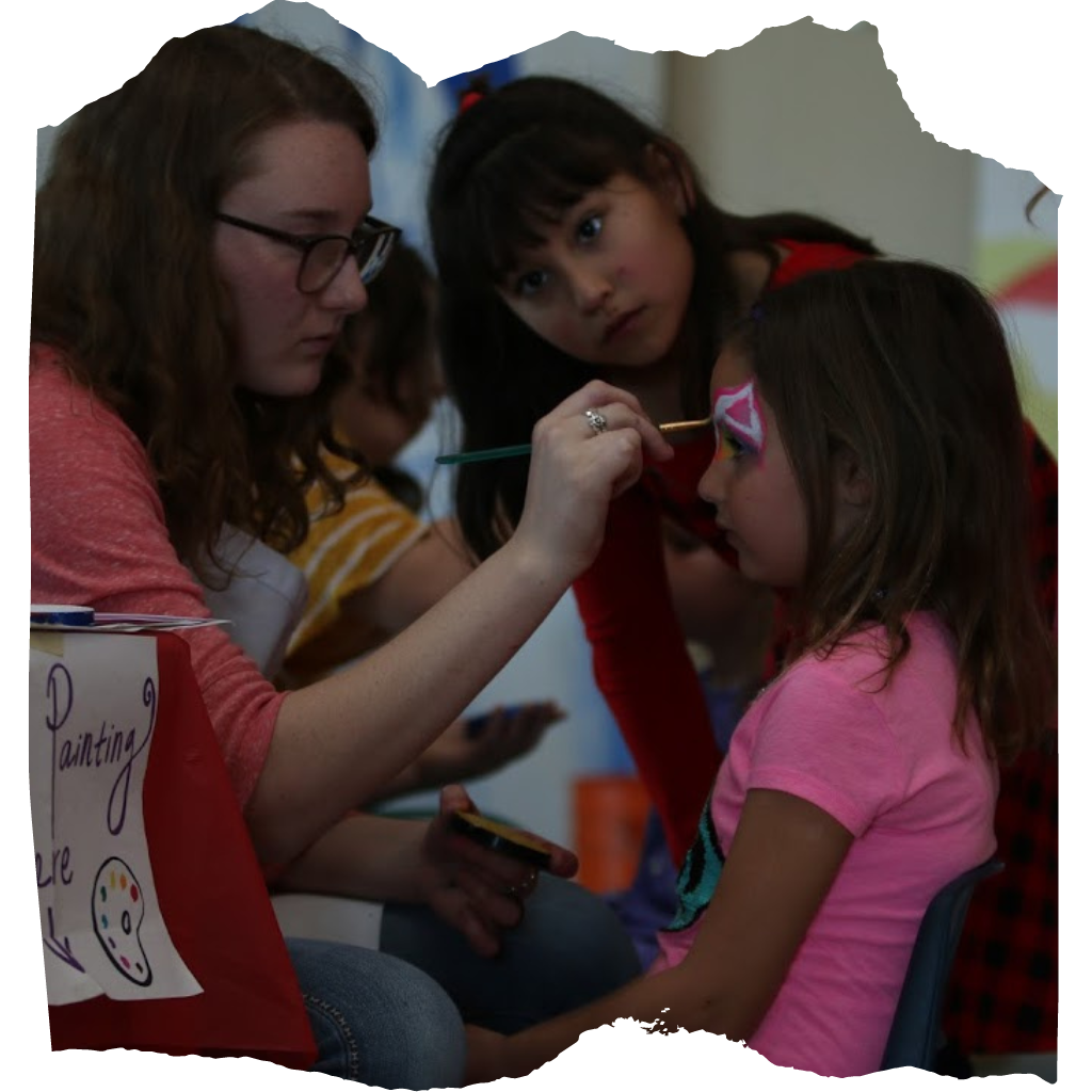 assistant face painting included in the student and another students engaged
